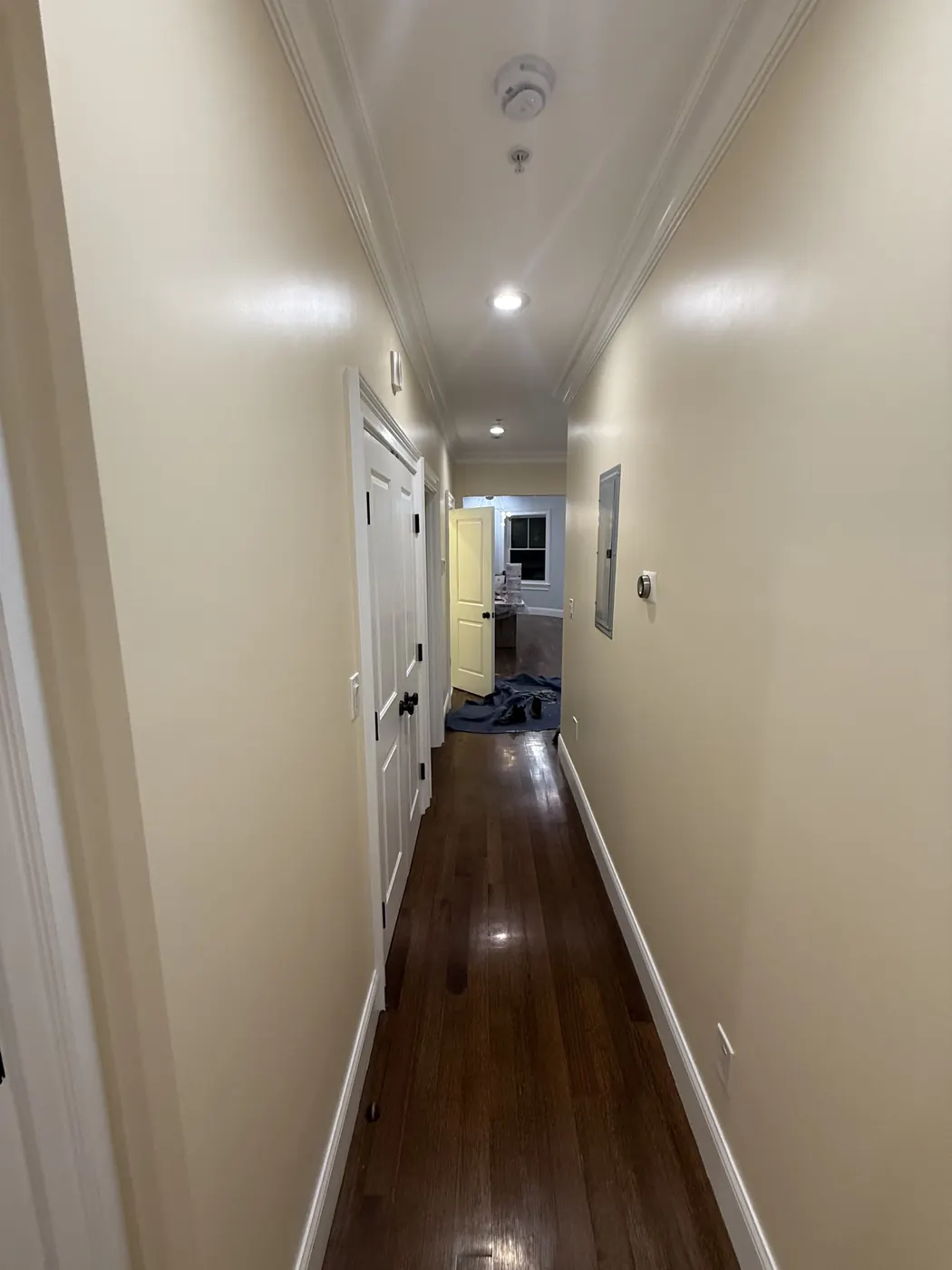 Hallway with smooth beige walls and white trim